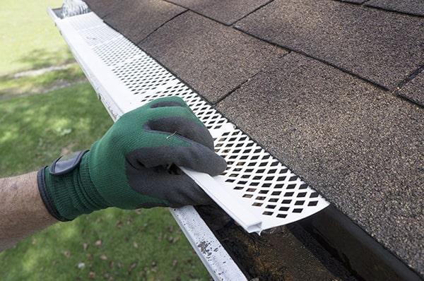 gutter guards act as a barrier to prevent leaves, twigs, and other debris from entering and clogging the gutters